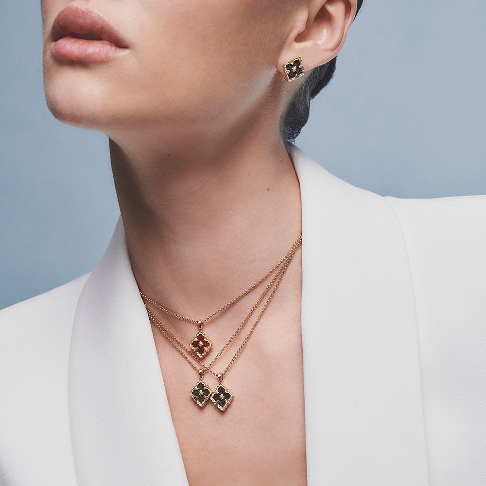 A black Burberry handbag with a stripe of red plaid.