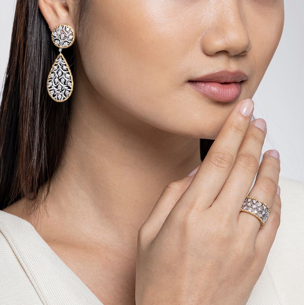 A sideboard filled with appetizers and canapes on silver trays and bowls.